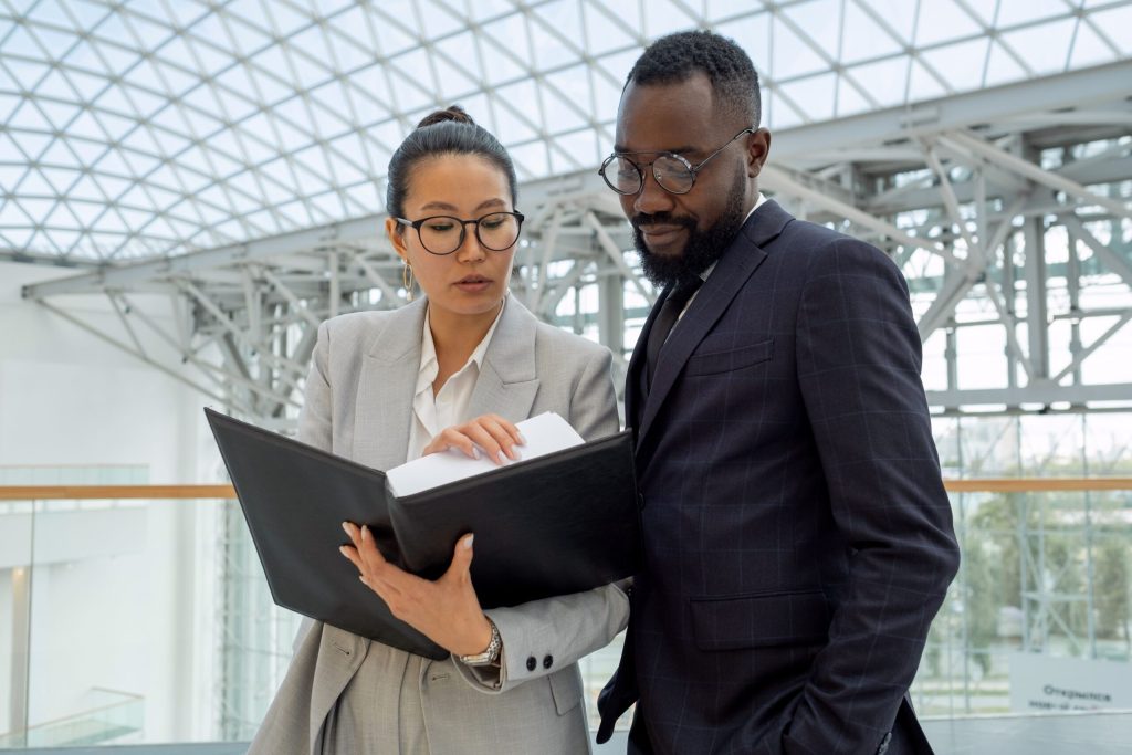 Two solicitors reading a guide to buying a property