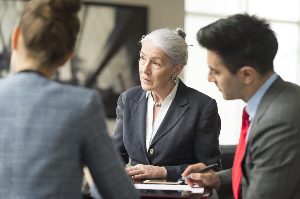 Three solicitors discussing assets in divorce