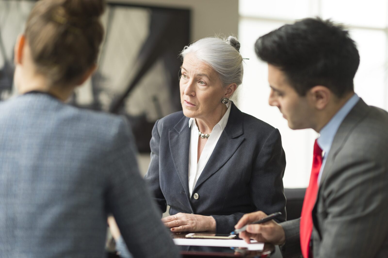 Three solicitors discussing assets in divorce