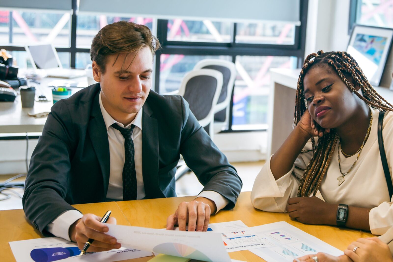A solicitor explaining a successful MBO sale with a client