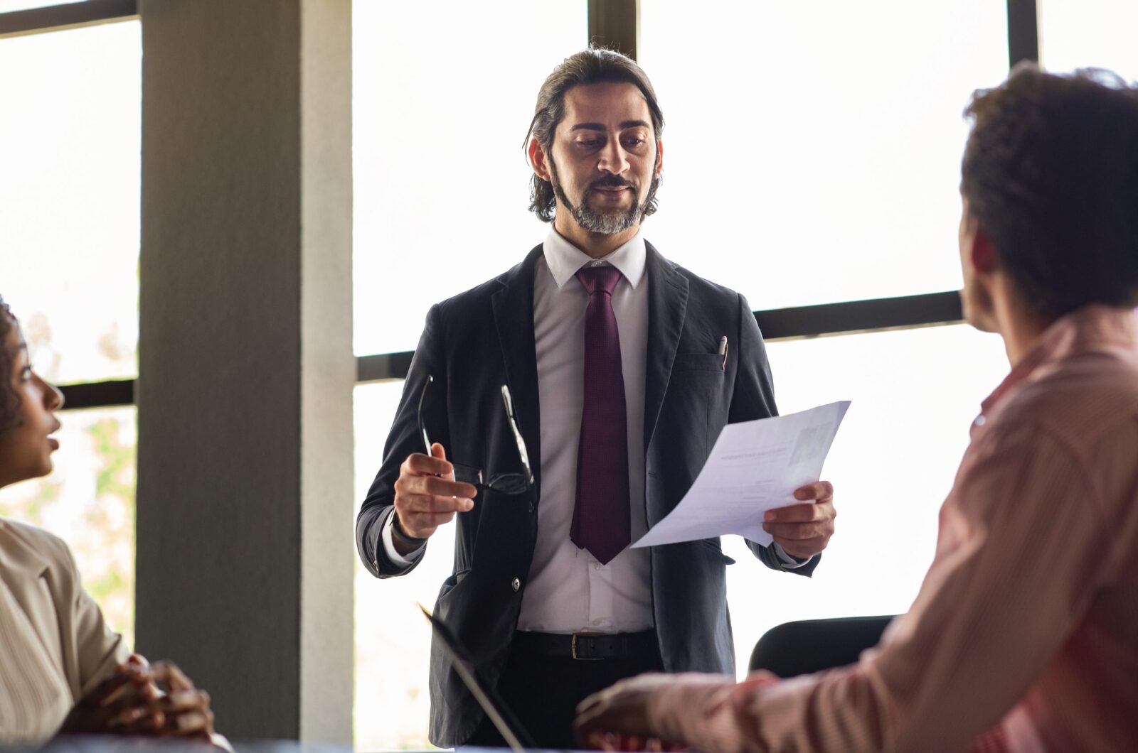 A solicitor explaining the benefits of a partnership merger to a client